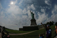 The Monument of Liberty State is photographed while the solar eclipse is seen over Liberty State Island in New York, U.S., August 21, 2017. Location coordinates for this image are 40.4124°N, 74.237°W. REUTERS/Eduardo Munoz