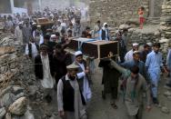 Relatives and residents carry the coffins of victims after a suicide attack during a burial ceremony in the Dari Noor district of Nangarhar province April 18, 2015. (REUTERS/Parwiz)