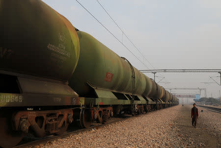 A boy walks past an oil tanker train stationed at a railway station in Ghaziabad, on the outskirts of New Delhi, India, February 1, 2019. REUTERS/Anushree Fadnavis