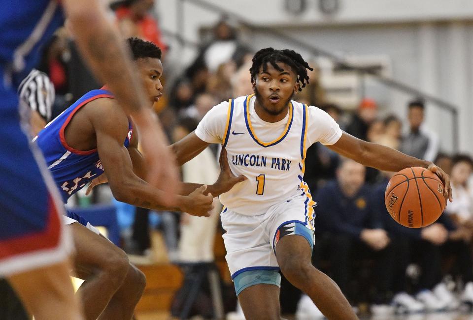 Lincoln Park's DeAndrea Moye brings the ball down the court as Laurel Highlands defends during the Central Valley Roundball Classic Thursday at the Community College of Beaver County Dome. Lincoln Park won the game.