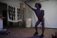 Transgender Crystal performs against racism and discrimination in one of the weekly presentations put on by residents on a makeshift stage in the squat known as Casa Nem, occupied by members of the LGBTQ community who are in self-quarantine as a protective measure against the new coronavirus, in Rio de Janeiro, Brazil, Saturday, May 23, 2020. (AP Photo/Silvia Izquierdo)