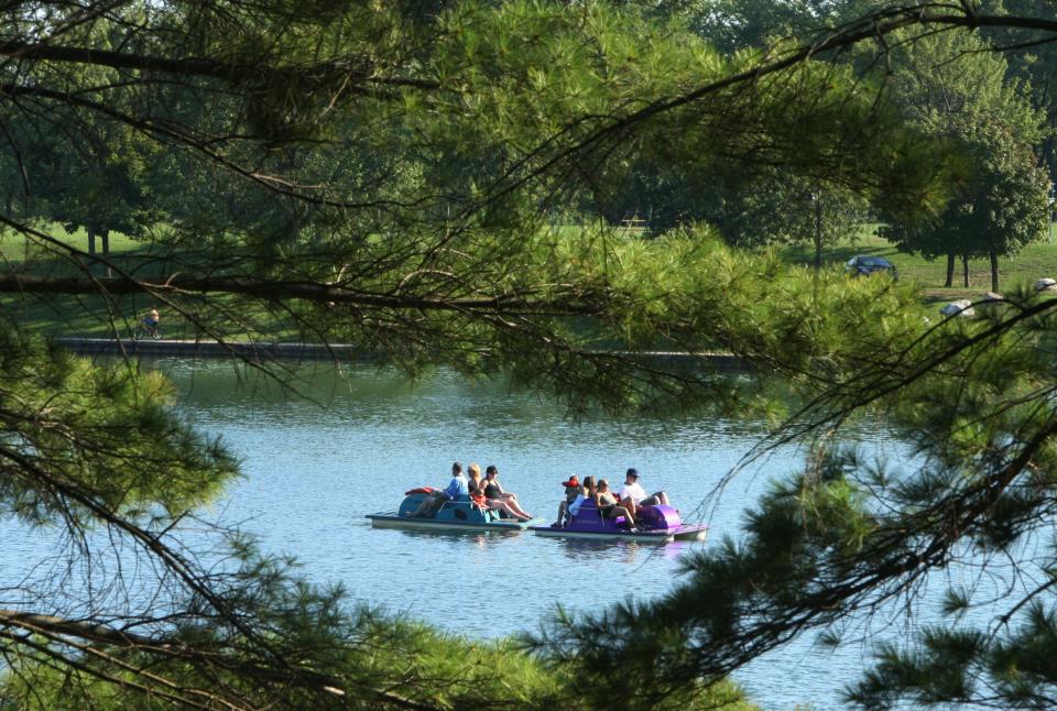 Campers relax on paddleboats in one of the small lakes at Camp Dearborn in Milford, Sunday, September 2, 2007.