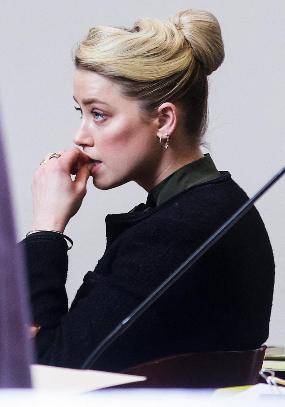 Actor Amber Heard listens to her attorney's questions during the testimony of clinical and forensic psychologist Dr Shannon Curry (not pictured) during Depp's defamation trial against her, at the Fairfax County Circuit Courthouse in Fairfax, Virginia, on May 25, 2022