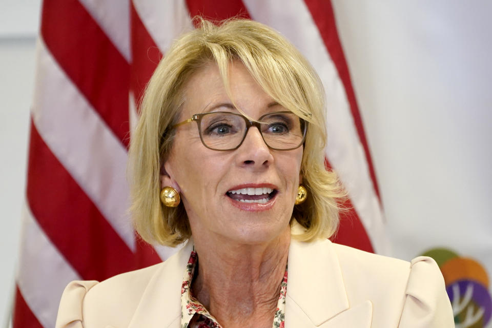 FILE - In this Oct. 15, 2020, file photo, Secretary of Education Betsy DeVos speaks at the Phoenix International Academy in Phoenix. Thousands of public servants who were rejected from a student loan forgiveness program will get their cases reviewed by the Education Department as part of a new settlement in a lawsuit brought by one of the nation's largest teachers unions. According to the lawsuit, the Education Department routinely made errors while processing applications, yet offered no appeals process. It argued that borrowers were illegally being denied their right to due process. The suit targeted the department and former Education Secretary Betsy DeVos. (AP Photo/Matt York, File)