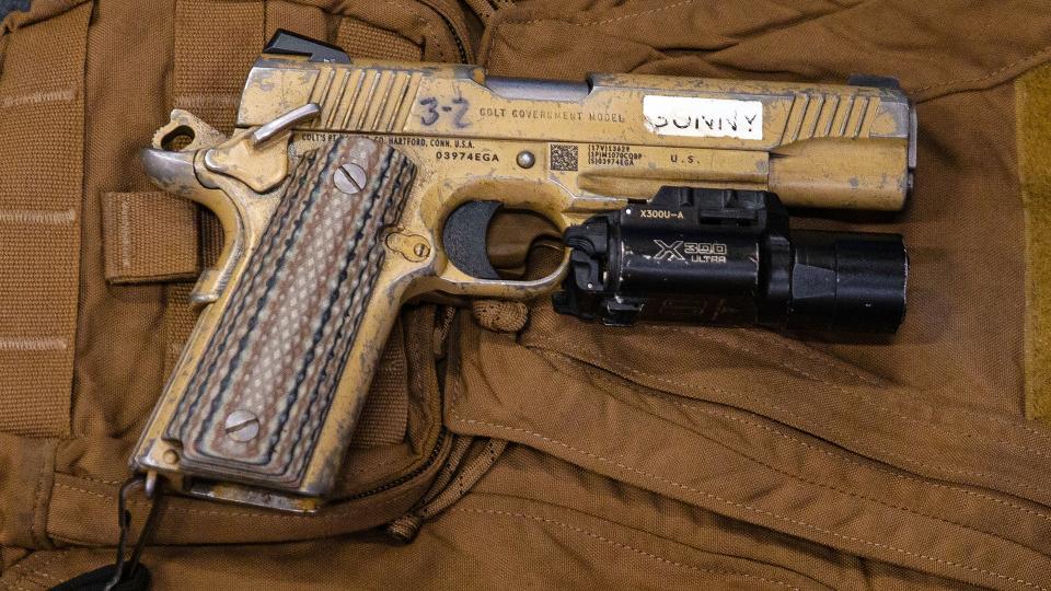 An M45A1 pistol is laid out on top of a Force Reconnaissance Marine’s loadout prior to a visit, board, search and seizure (VBSS) operation aboard the amphibious assault ship USS America (LHA 6), Philippine Sea, Feb. 2, 2022. (U.S. Marine Corps photo by Lance Cpl. Cesar Ronaldo Alarcon)