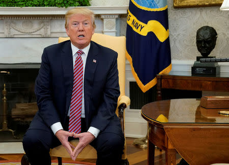 U.S. President Donald Trump speaks to reporters in the Oval Office at the White House in Washington, U.S., February 9, 2018. REUTERS/Jonathan Ernst