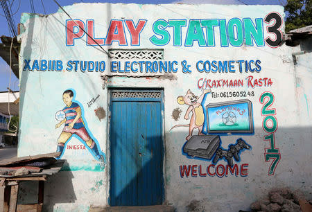 A mural on a shop front shows a PlayStation 3 in Hamarweyne district of Mogadishu, Somalia, June 8, 2017. REUTERS/Feisal Omar