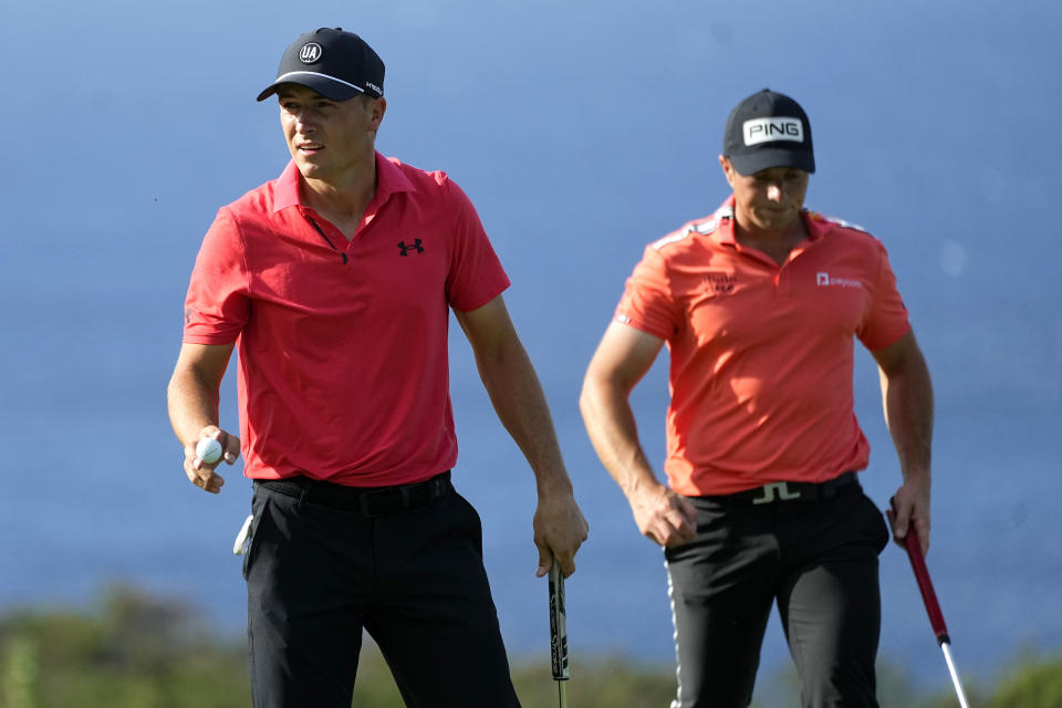 Jordan Spieth, left, waves, from the 14th green during the first round of The Sentry golf event, Thursday, Jan. 4, 2024, at Kapalua Plantation Course in Kapalua, Hawaii. (AP Photo/Matt York)