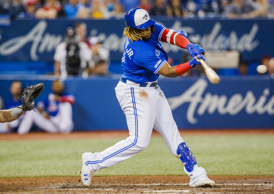 TORONTO, ONTARIO - JULY 27: Vladimir Guerrero Jr. #27 of the Toronto Blue Jays hits a double against the Tampa Bay Rays in the sixth inning during their MLB game at the Rogers Centre on July 27, 2019 in Toronto, Canada. (Photo by Mark Blinch/Getty Images)