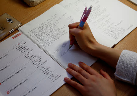 Nao Niitsu, 19, a college freshman from Tokyo, who wants to be a K-pop star, studies Korean in her room in Tokyo, Japan, March 20, 2019. REUTERS/Kim Kyung-Hoon