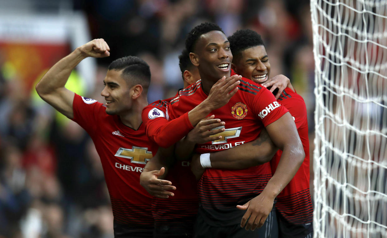 Manchester United's Anthony Martial, centre, celebrates scoring his side's second goal of the game with teammates, during the English Premier League soccer match between Manchester United and Watford, at Old Trafford, in Manchester, England, Saturday March 30, 2019. (Martin Rickett/PA via AP)