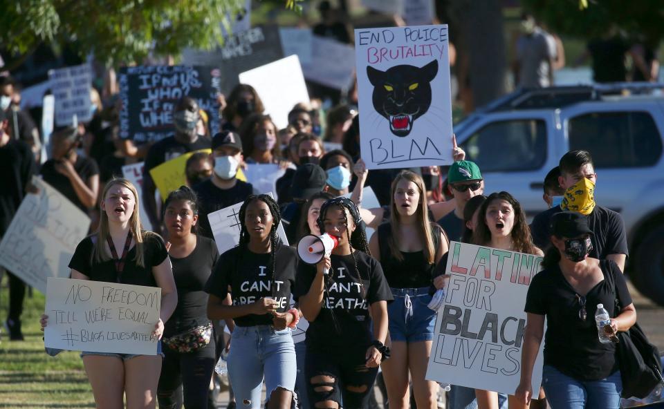 Protesters march during a rally at Cesar Chavez Park on Wednesday, June 3, 2020, in Laveen, Ariz., protesting the death of George Floyd, who died May 25 after being restrained by Minneapolis police.