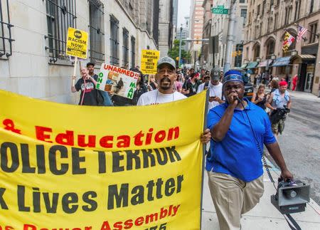 Activist C.D. Witherspoon (R) leads a small group of protestors through the city on the second day of pretrial motions for six police officers charged in connection with the death of Freddie Gray in Baltimore, Maryland September 10, 2015. REUTERS/Bryan Woolston