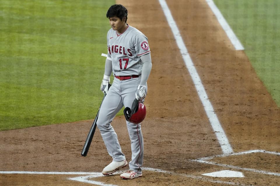 Los Angeles Angels' Shohei Ohtani walks to the dugout after striking out in the third inning of a baseball game against the Texas Rangers in Arlington, Texas, Monday, Aug. 2, 2021. (AP Photo/Tony Gutierrez)