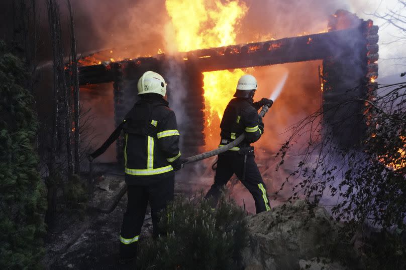 Firefighters put out a fire after a house was hit by Russian shelling in Kharkiv, Ukraine, Saturday, May 4, 2024.