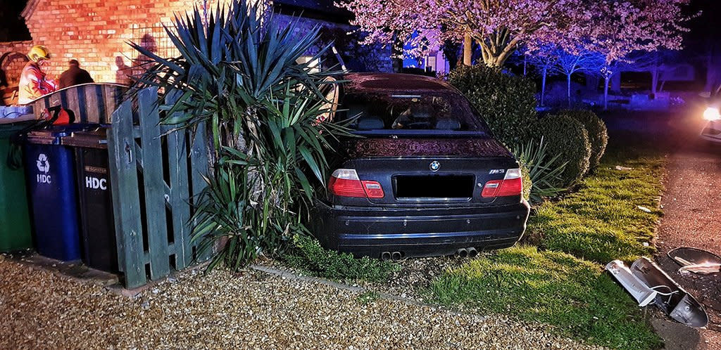 This BMW left a trail of destruction after smashing through walls and narrowly missing a home in Woodhurst, Cambridgeshire. (SWNS)