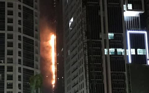 Flames shoot up the side of the Torch tower residential building in the Marina district, Dubai - Credit: Reuters