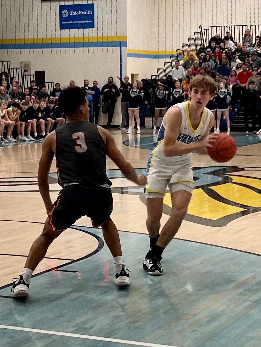 River Valley's Carson Smith looks to make a play against the defense of Shelby's Isaiah Ramsey during Saturday night's Mid Ohio Athletic Conference boys basketball game at River Valley.