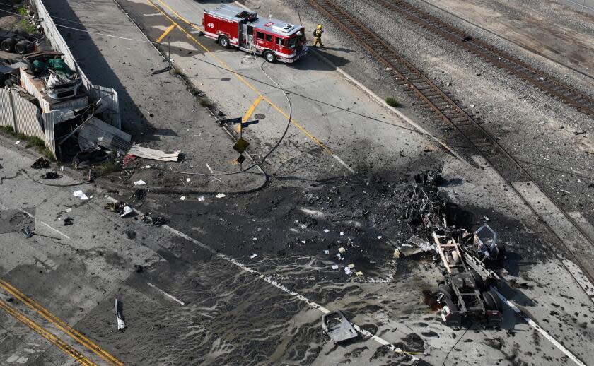 Wilmington, CA - February 15: Aerial view of a Los Angeles Fire Dept. firefighter and truck at the scene of a truck explosion where several firefighters were injured, at least two critically, in an explosion involving a truck with pressurized cylinders in Wilmington Thursday, Feb. 15, 2024. Firefighters were sent to the 1100 block of North Alameda Street shortly before 7 a.m., according to Nicholas Prange of the Los Angeles Fire Department. ``Several other injured are being evaluated on scene, awaiting additional ambulances to arrive -- (an) estimated seven total firefighters,'' Prange said.(Allen J. Schaben / Los Angeles Times)