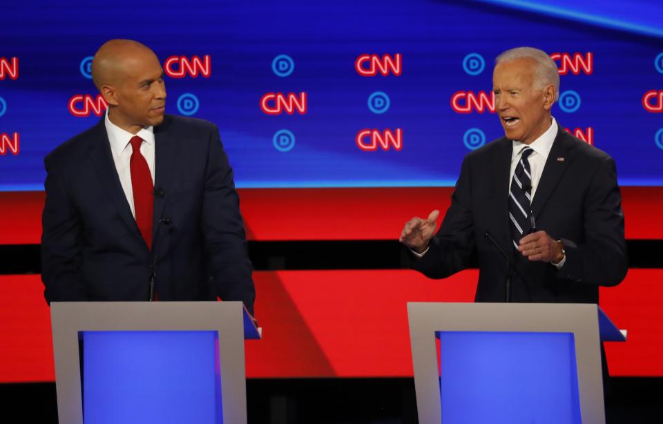 Former Vice President Joe Biden and Sen. Cory Booker, D-N.J., left, participate in the second of two Democratic presidential primary debates hosted by CNN Wednesday, July 31, 2019, in the Fox Theatre in Detroit. (AP Photo/Paul Sancya)