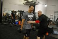 WWE wrestler Bin Wang (C) of China works out with trainer Sean Hayes at the WWE Performance Center in Azalea Park, Florida, December 1, 2016. REUTERS/Scott Audette