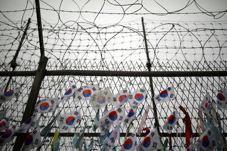 South Korean national flags hang on a barbed-wire fence near the demilitarized zone separating the two Koreas in Paju, South Korea, August 14, 2017. REUTERS/Kim Hong-Ji