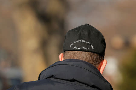 An agent wearing a FBI Bomb Technician hat walks outside a home in the Brooklyn borough of New York City, while they investigate an earlier incident of the reported explosion at the New York Port Authority Bus Terminal in Manhattan, in New York City, New York, U.S. December 11, 2017. REUTERS/Lucas Jackson