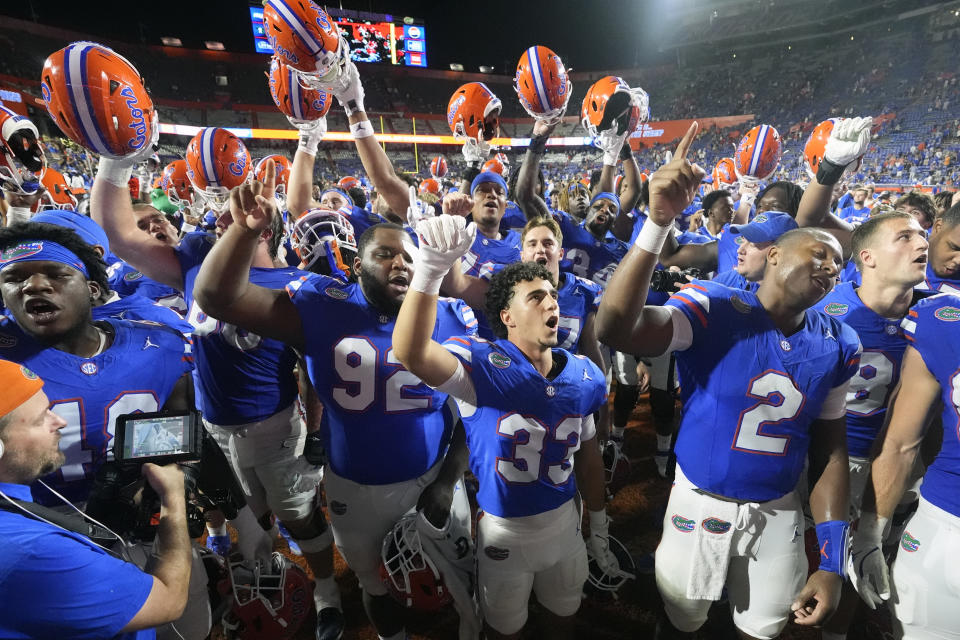 Florida players celebrate after defeating Central Florida in an NCAA college football game, Saturday, Oct. 5, 2024, in Gainesville, Fla. (AP Photo/John Raoux)