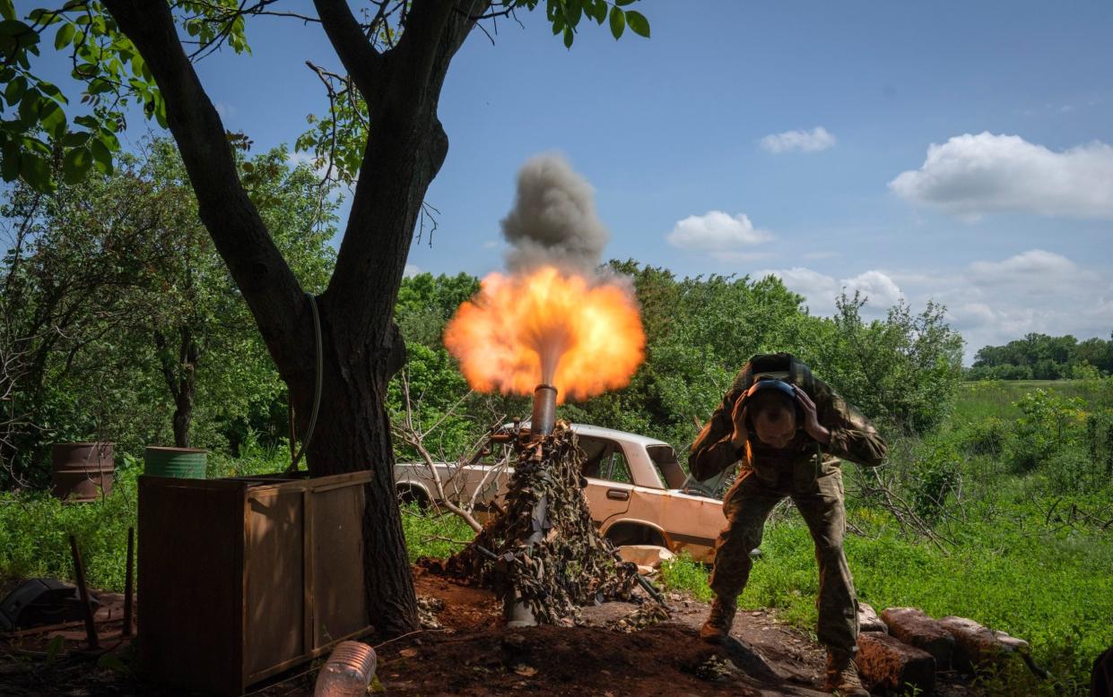 A Ukrainian soldier fires a mortar at Russian positions on the front line near Bakhmut - Efrem Lukatsky/AP