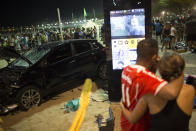 <p>People watch the site of the accident where a car that has driven into the crowded seaside boardwalk along Copacabana beach in Rio de Janeiro, Brazil, Thursday, Jan. 18, 2018. (Photo: Silvia Izquierdo/AP) </p>