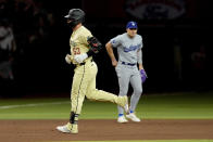 Arizona Diamondbacks' Christian Walker rounds the bases after hitting a solo home run against the Los Angeles Dodgers during the fourth inning of a baseball game, Tuesday, April 30, 2024, in Phoenix. (AP Photo/Matt York)