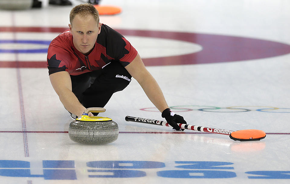 Canada's Brad Jacobs delivers the rock during the men's curling training session at the 2014 Winter Olympics, Sunday, Feb. 9, 2014, in Sochi, Russia. (AP Photo/Wong Maye-E)