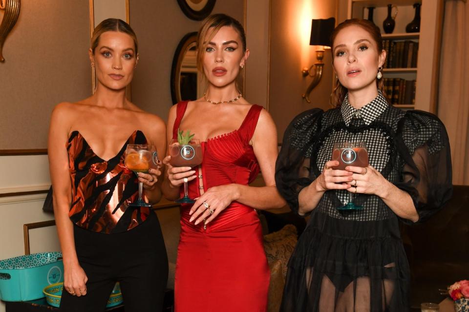 Cocktail Reception With Malfy Gin Pre British Fashion Awards: Laura Whitmore, Abbey Clancy and Angela Scanlan are pictured enjoying a Malfy cocktail ahead of The Fashion Awards 2022, at 11 Cadogan Gardens on December 5, 2022 in London, England. Inspired by the stylish Amalfi lifestyle, and embodying the essence of 'La Dolce Vita', Malfy Gin is an official partner of The Fashion Awards this year. (Dave Benett)