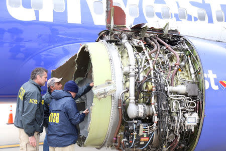 U.S. NTSB investigators are on scene examining damage to the engine of the Southwest Airlines plane in this image released from Philadelphia, Pennsylvania, U.S., April 17, 2018. NTSB/Handout via REUTERS