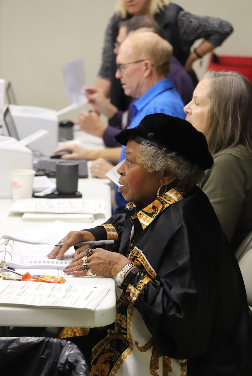 Angie Ray processes voters for the midterm elections Tuesday, Nov. 8, 2022, at Oak Street Baptist Church in Burlington.