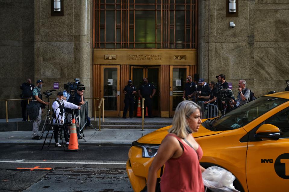 People walk past the Criminal Courts building and District Attorneys office  in Manhattan,where long-serving chief financial officer of former president Donald Trump's company, Allen Weisselberg is being held on July 1, 2021 in New York. - Former president Donald Trump's company and its long-serving chief financial officer are to be charged on July 1, 2021 with tax-related crimes, US media reported. They would mark the first criminal charges in a more than two-year investigation by the Manhattan district attorney into alleged fraud at the Trump Organization. (Photo by Ed JONES / AFP) (Photo by ED JONES/AFP via Getty Images)