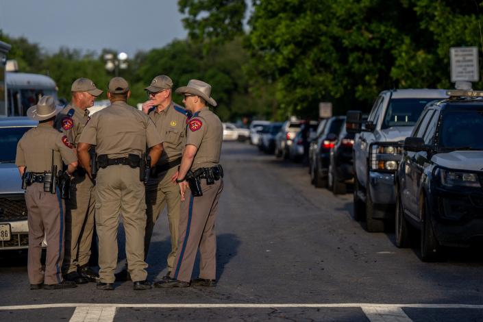 Law enforcement officers gather outside of Robb Elementary School following the mass shooting there on May 25, 2022 in Uvalde, Texas.