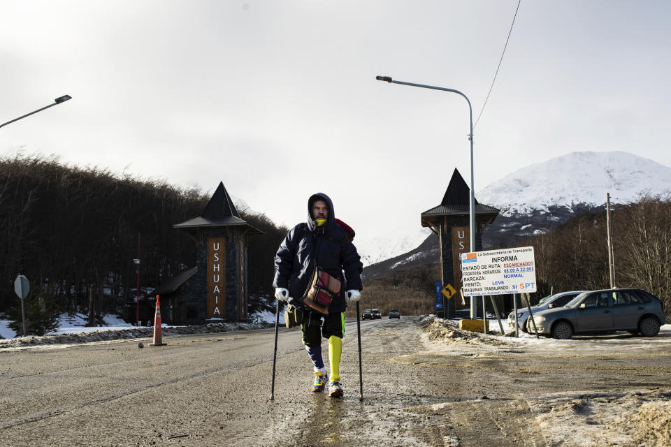 Venezuelan Yeslie Aranda, 57, makes good on his promise to travel throughout South America with one leg and a prosthesis as he enters the southernmost city in the world, Ushuaia, Argentina, Saturday, Aug. 17, 2019. Six years ago Aranda was driving a long distance bus in the Venezuelan state of Barinas, when a truck traveling in the opposite direction lost control and crashed into his vehicle. Aranda and his 23-year-old daughter, Paola, each lost a leg and were hospitalized for several weeks. (AP Photo/Luján Agusti)