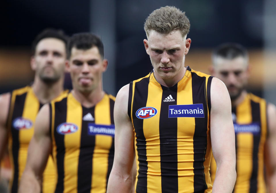 James Sicily and his team mates look dejected as they leave the field after defeat during the round 7 AFL match between the Hawthorn Hawks and the Melbourne Demons.