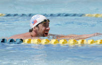 Michael Phelps warms up prior to competing in the 100 Butterfly during the Arena Grand Prix at Mesa, Thursday, April 24, 2014, in Mesa, Ariz. It is Phelps' first competitive event after a nearly two-year retirement. (AP Photo/Matt York)