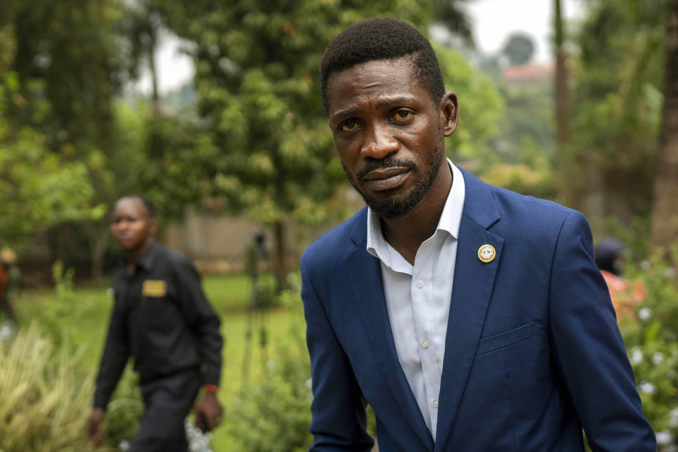 FILE- in this Jan. 15, 2021 file photo, Uganda's leading opposition challenger Bobi Wine walks back to his residence after giving a press conference outside Kampala, Uganda. Despite failing to dislodge the long-time leader President Yoweri Museveni, Wine has emerged from Jan. 14, 2021 disputed polls as the country's most powerful opposition leader after his party won the most seats of any opposition group in the national assembly. (AP Photo/Jerome Delay, File)