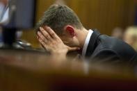 Oscar Pistorius reacts during his trial at the high court in Pretoria April 7, 2014. Pistorius is on trial for the murder of his girlfriend Reeva Steenkamp on Valentine's Day in 2013. REUTERS/Deaan Vivier/Pool