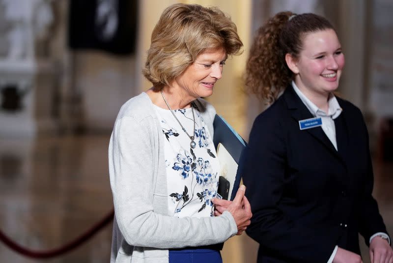 Senator Lisa Murkowski speaks to a Senate page after the House of Representatives named managers for the Senate impeachment trial of U.S. President Donald Trump at the U.S. Capitol in Washington