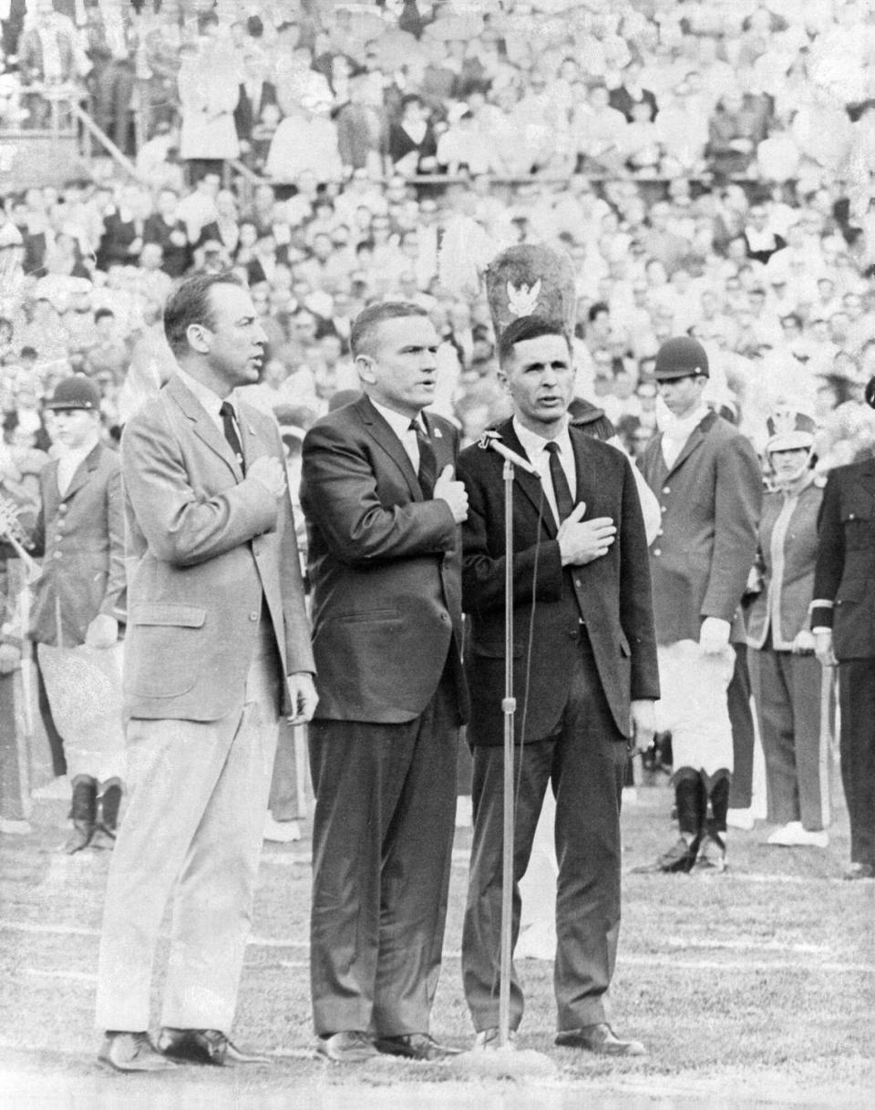 At Super Bowl III in Miami, Apollo 8 moon visitors lead pledge of allegiance. From left, Capt. James Lovell, Col. Frank Borman and Lt. Col. William Anders. Date Shot: Jan. 12, 1969.