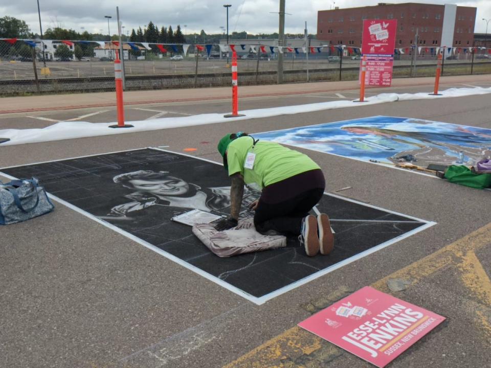 A black and white portrait of Elvis starts to take shape on Canada Street in Moncton, N.B.