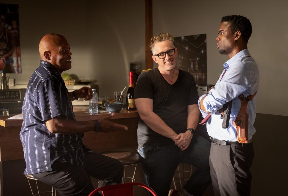 Samuel L. Jackson, left, talks with director Darren Lynn Bousman and Chris Rock on the set of "Spiral."