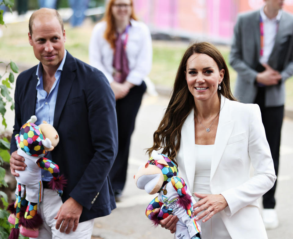 the two walking outside holding stuffed animals