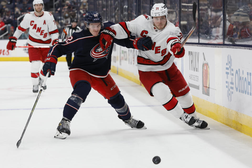 Columbus Blue Jackets' Jake Bean, left, and Jesper Fast chase a loose puck during the third period of an NHL hockey game Saturday, Jan. 1, 2022, in Columbus, Ohio. (AP Photo/Jay LaPrete)