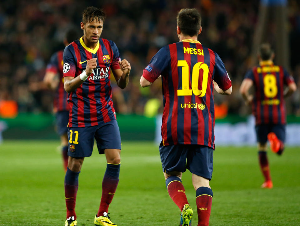 Barcelona's Neymar, left, celebrates with teammate Lionel Messi after scoring his side's first goal during a first leg quarterfinal Champions League soccer match between Barcelona and Atletico Madrid at the Camp Nou stadium in Barcelona, Spain, Tuesday April 1, 2014. (AP Photo/Emilio Morenatti)