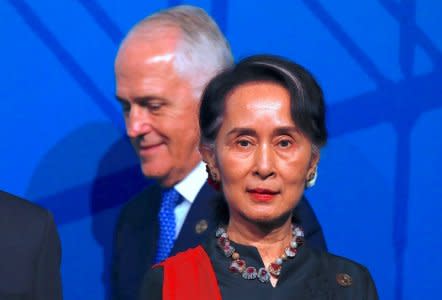 Australia's Prime Minister Malcolm Turnbull walks behind Myanmar's State Counsellor Aung San Suu Kyi during the Leaders Welcome and Family Photo at the one-off summit of 10-member Association of Southeast Asian Nations (ASEAN) in Sydney, Australia, March 17, 2018.  REUTERS/David Gray